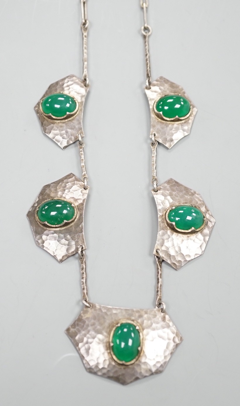 An Arts of Crafts planished white metal and five stone chrysoprase set necklace, 54cm.